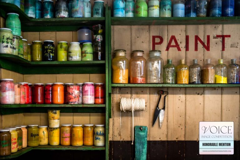 Shelves full of colourful jars of pigment at "Paint Bar" in Lewes, East Sussex.