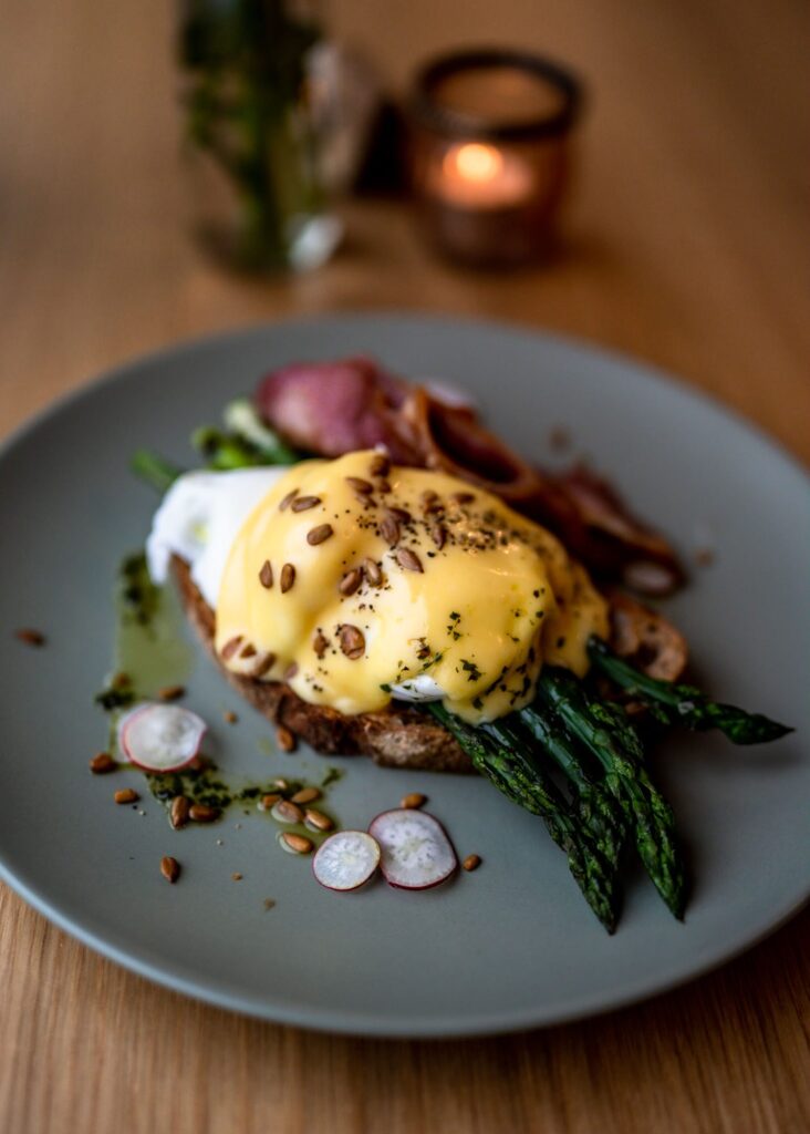 Eggs Benedict on a grey plate in a café in East Sussex.