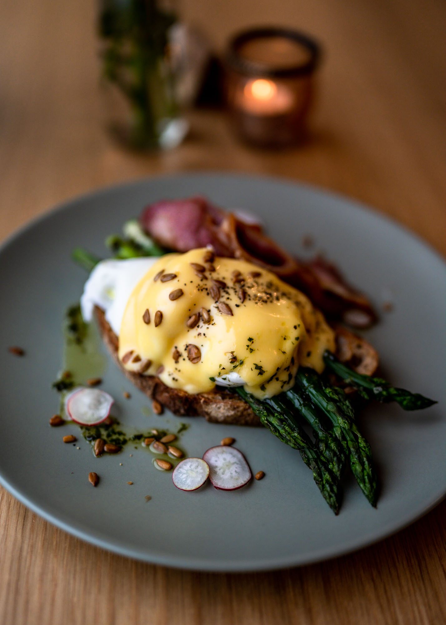 Eggs Benedict on a grey plate in a café in East Sussex.