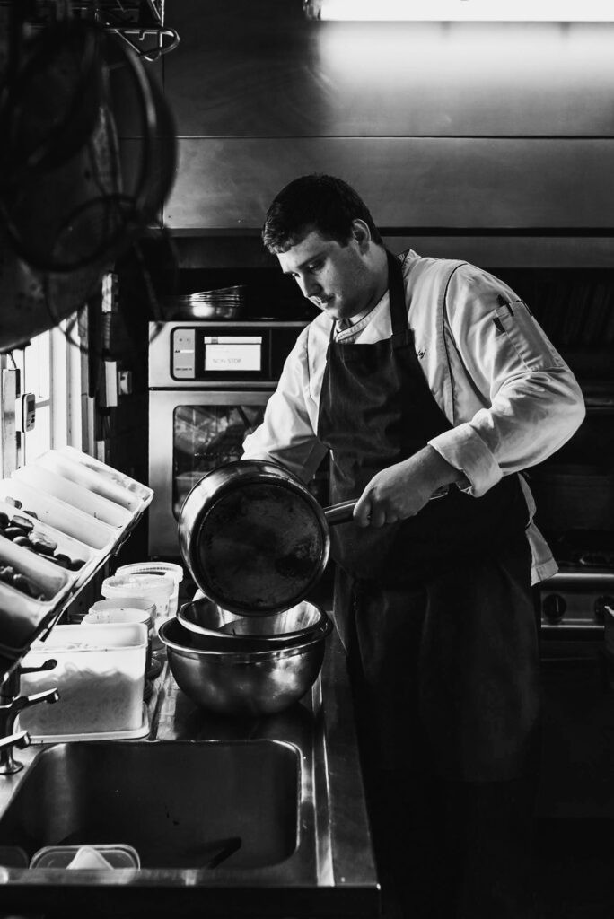 B&W white male chef in a commercial kitchen