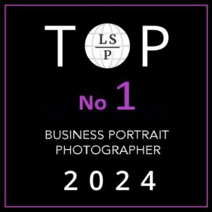 Badge stating TOP LSP No.1 Business Portrait Photographer 2024 in white text on a black background