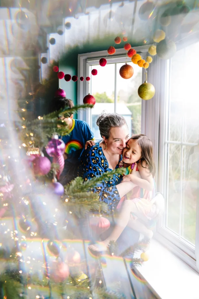 Bex a white woman enjoying Christmas Cuddles with her twins for a Headshot